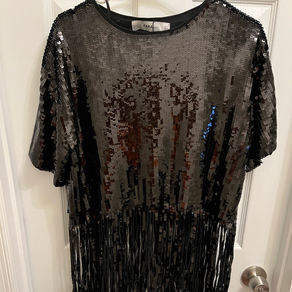 Black sequin fringe bottom knit top.